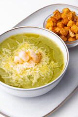Photo of soup creme with shrimps parmesan and crackers
