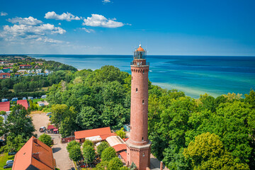 Lighthouse by Baltic Sea. Tourism by the sea in Poland - obrazy, fototapety, plakaty
