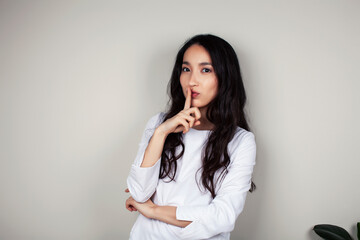 young asian woman doctor in white uniform gesturing positive on gray background, lifestyle healthcare people concept