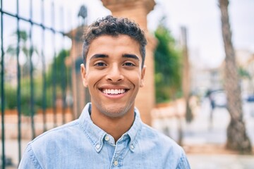 Fototapeta premium Young latin man smiling happy walking at the city.