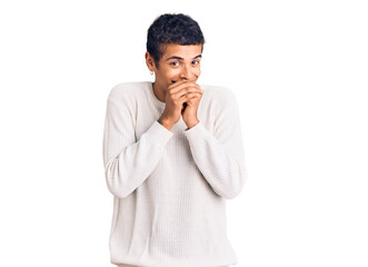 Young african amercian man wearing casual clothes laughing nervous and excited with hands on chin looking to the side