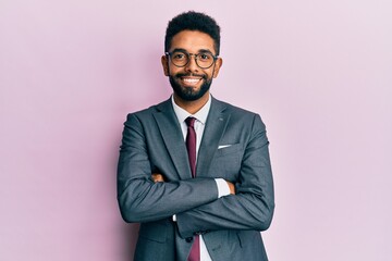 Handsome hispanic business man with beard wearing business suit and tie happy face smiling with crossed arms looking at the camera. positive person.