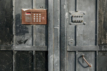 Old vintage intercom doorbell on apartment building doors