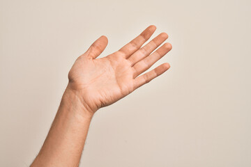 Hand of caucasian young man showing fingers over isolated white background presenting with open palm, reaching for support and help, assistance gesture
