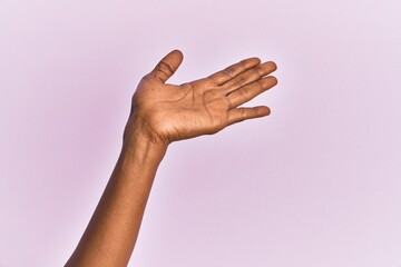 Arm and hand of black middle age woman over pink isolated background presenting with open palm, reaching for support and help, assistance gesture