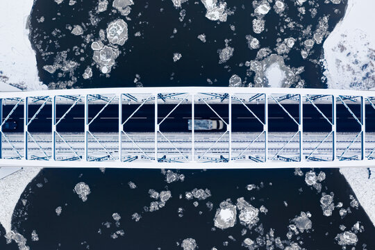 Bridge and river full of floes in winter, aerial view
