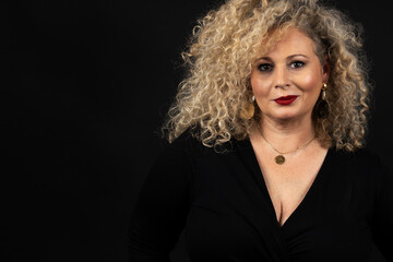 Fototapeta premium portrait of mature woman plus size model, xxl woman on black background