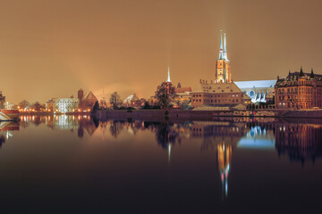 Fototapeta na wymiar Cathedral of St. John the Baptist in Wroclaw on the Odra River, illuminated at night.