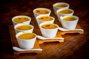 Creme brulee in characteristic ramekins, sweet dessert based on egg cream and vanilla with burnt sugar in the torch