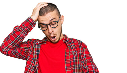 Hispanic young man wearing casual clothes looking at the watch time worried, afraid of getting late