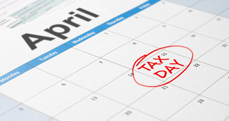 Writing tax day on April 15 calendar with red marker. Deadline for 1040 form return.