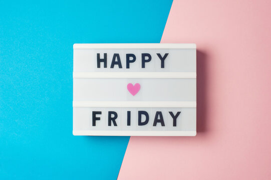 Happy Friday - text on display lightbox on blue and pink background.