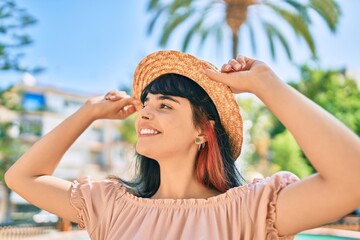 Young hispanic tourist girl wearing summer style walking at the park.