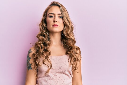 Young blonde girl wearing casual clothes relaxed with serious expression on face. simple and natural looking at the camera.