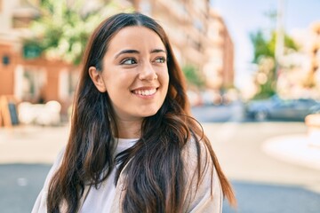 Young hispanic woman smiling happy walking at the city.