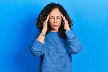 Middle age hispanic woman wearing casual clothes with hand on head for pain in head because stress....