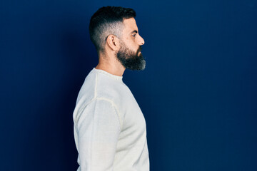 Obraz premium Young hispanic man wearing casual clothes looking to side, relax profile pose with natural face with confident smile.