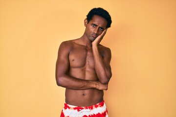 Fototapeta premium African handsome man wearing swimsuit thinking looking tired and bored with depression problems with crossed arms.