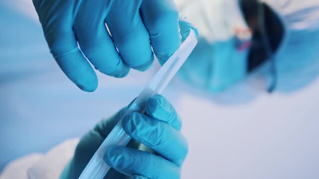 Vaccination and immunization against covid-19. Doctor opening needle. Close up. Vertical. High quality 4k footage