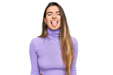 Young hispanic woman wearing casual clothes sticking tongue out happy with funny expression. emotion concept.