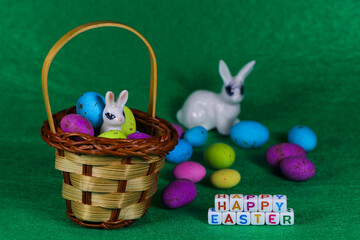 Happy Easter Bunny In Basket With Colorful Eggs
