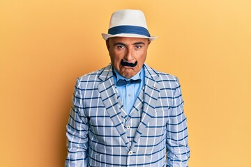 Mature middle east man with mustache wearing vintage and elegant fashion style depressed and worry for distress, crying angry and afraid. sad expression.