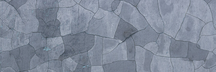 Obraz premium Peeling paint on the wall. Panorama of a concrete wall with old cracked flaking paint. Weathered rough painted surface with patterns of cracks and peeling. Panoramic texture for background and design.