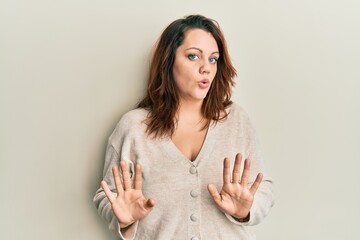Young caucasian woman wearing casual clothes moving away hands palms showing refusal and denial...