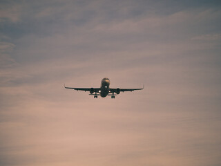 airplane flying at sunset