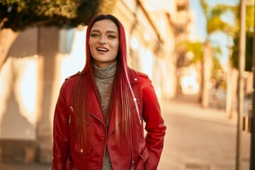 Fototapeta premium Young caucasian girl smiling happy standing at the city.