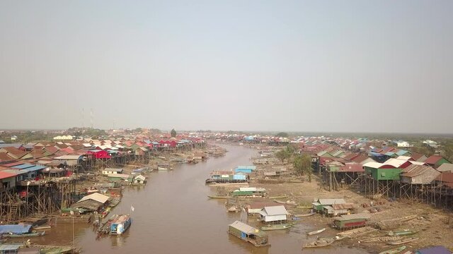 fly over a floating village of stilted houses along the tonle sap river