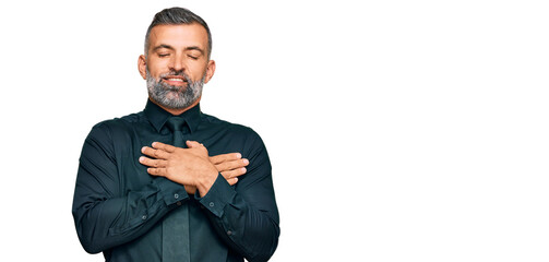 Middle age handsome man wearing business clothes smiling with hands on chest with closed eyes and grateful gesture on face. health concept.