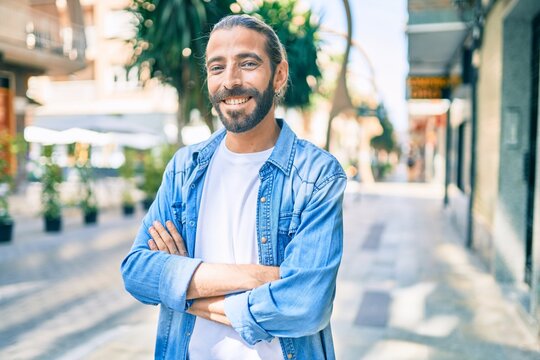 Young middle eastern man smiling happy walking at the city.