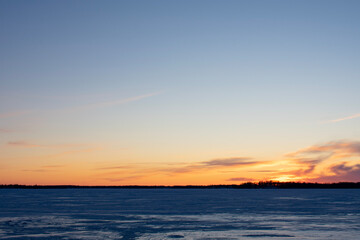 sunset over frozen lake