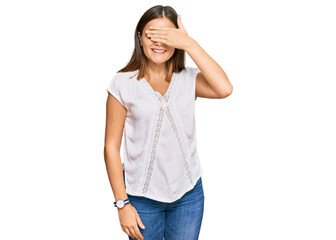 Fototapeta premium Young caucasian woman wearing casual clothes smiling and laughing with hand on face covering eyes for surprise. blind concept.