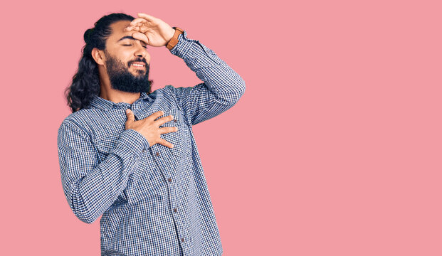 Young arab man wearing casual clothes touching forehead for illness and fever, flu and cold, virus sick