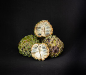 Sugar apple open in close up  on dark background.