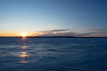 sunset over the frozen lake