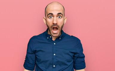 Young hispanic man wearing casual clothes afraid and shocked with surprise and amazed expression, fear and excited face.