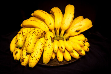Ripe and yellow bananas with black background isolated