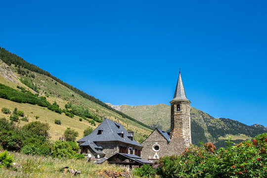 exterior view of the Montgarri high mountain refuge in summer, with the Pyrenees mountains of the Aran Valley in the background, Lleida, Spain