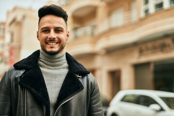 Young arab man smiling happy standing at the city.