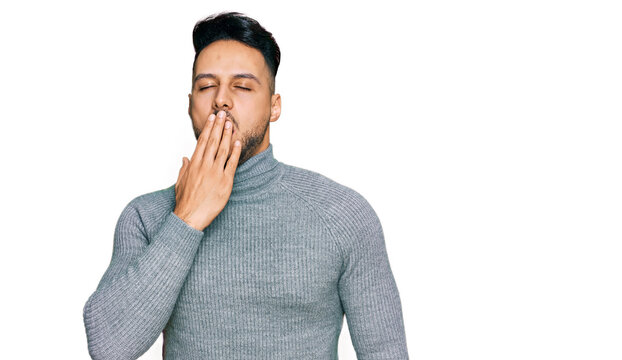 Young arab man wearing casual clothes bored yawning tired covering mouth with hand. restless and sleepiness.