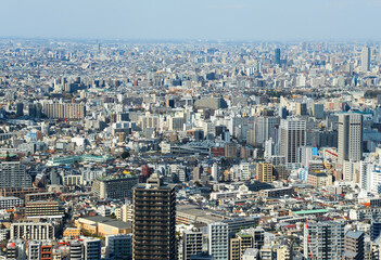 High angle view of Tokyo, Japan with countless buildings. Mix of high and low constructions. Biggest city in the world.
