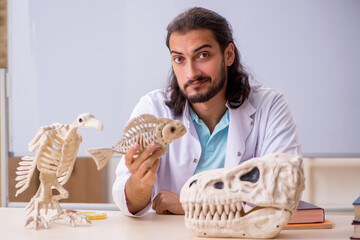 Young male paleontologist in front of the whiteboard