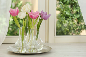 Fototapeta na wymiar Beautiful fresh tulips on window sill indoors. Spring flowers