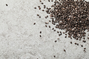 Pile of chia seeds on light grey table, flat lay. Space for text