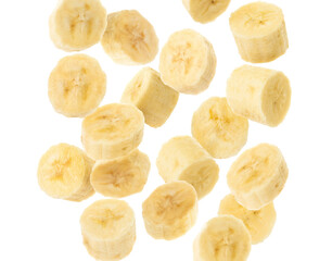 Slices of tasty ripe banana falling on white background