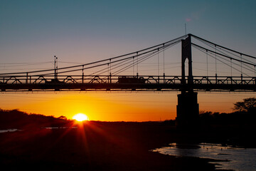 A nice sunset over a brige made of steel