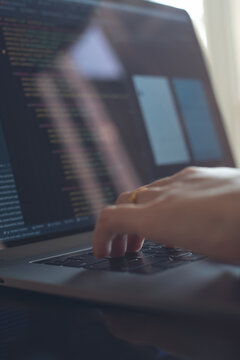 Digital software technology or mobile app development concept. Programmer, software developer coding Javascript on laptop computer